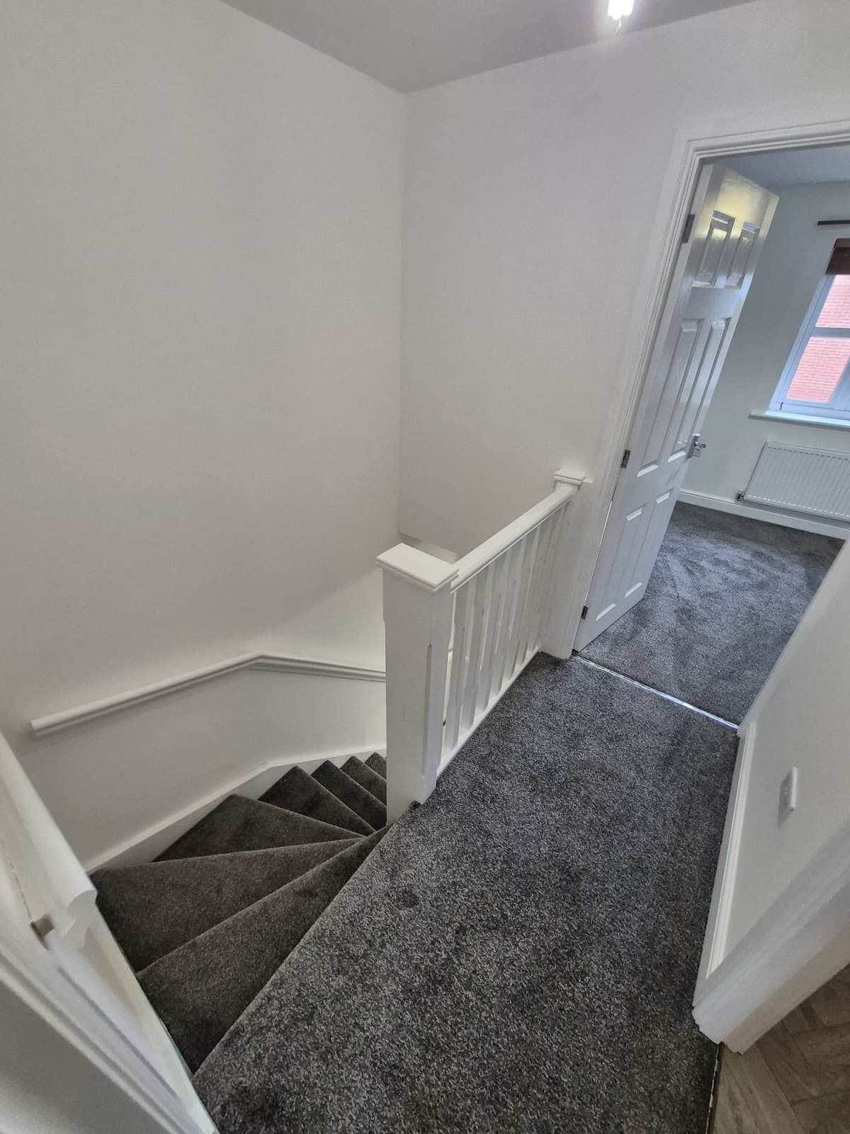 After — Full property renovation at 96 Maximus Avenue, Lincoln — landing and stairs with new grey carpet and fresh paint