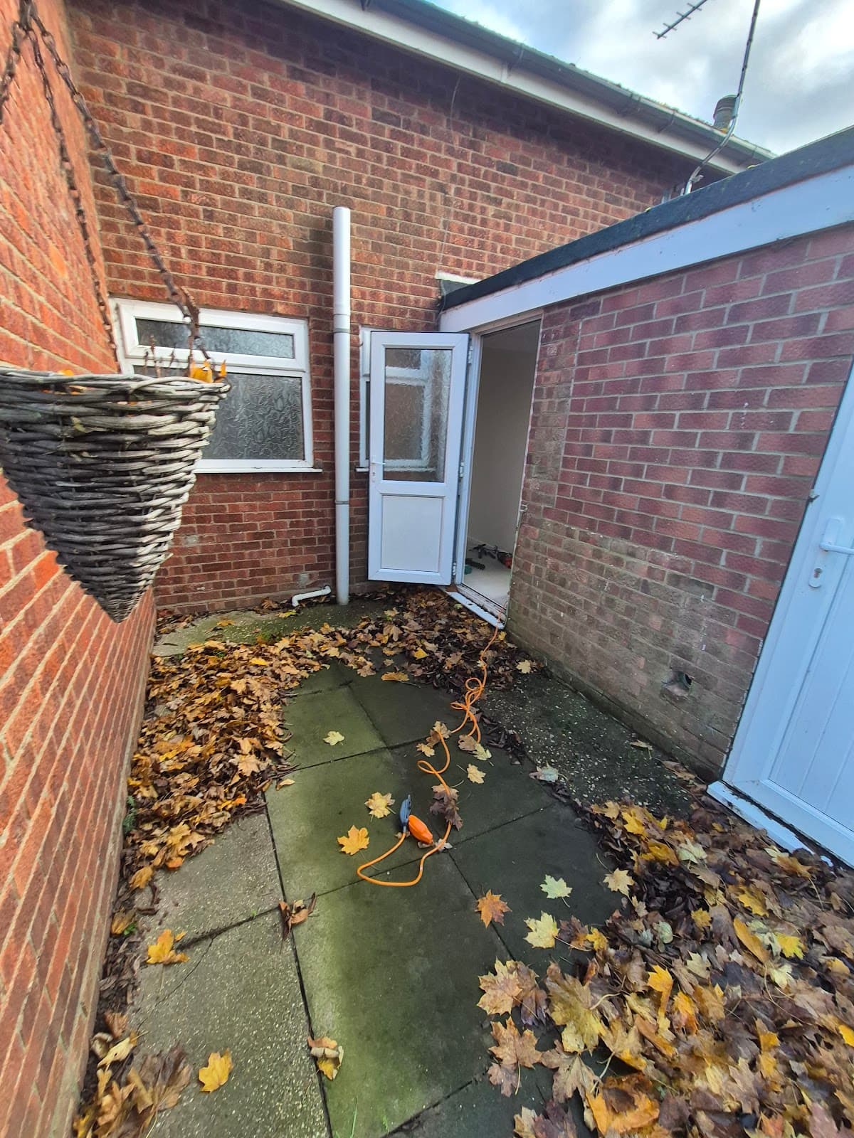 Before — Neglected rear yard requiring full clearance and garden maintenance, Lincoln