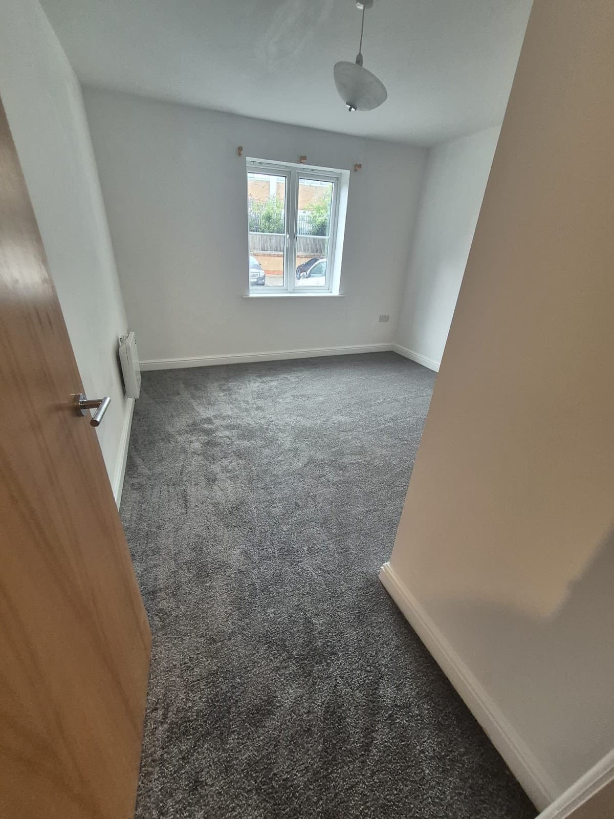 After — End of tenancy clean at 167 Riverside, Lincoln — bedroom freshly cleaned with new grey carpet