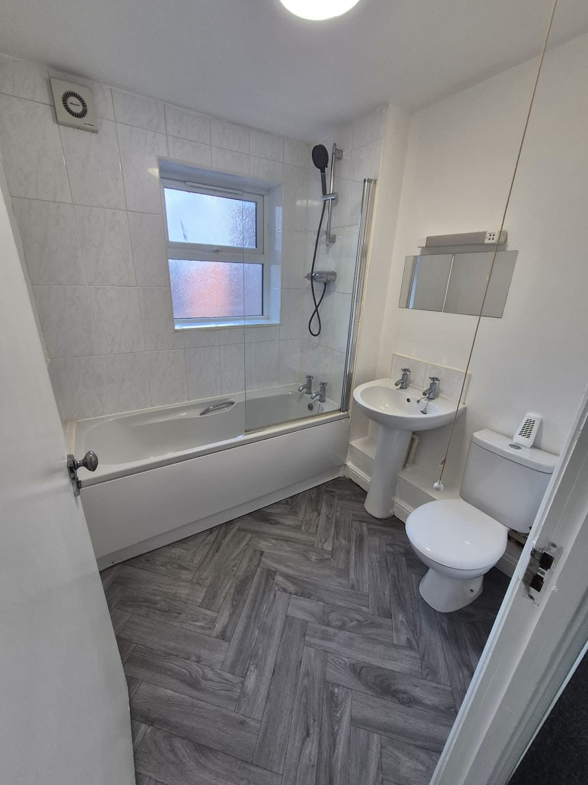 After — Refitted bathroom at Monson Mews, Lincoln — new white suite and herringbone vinyl flooring