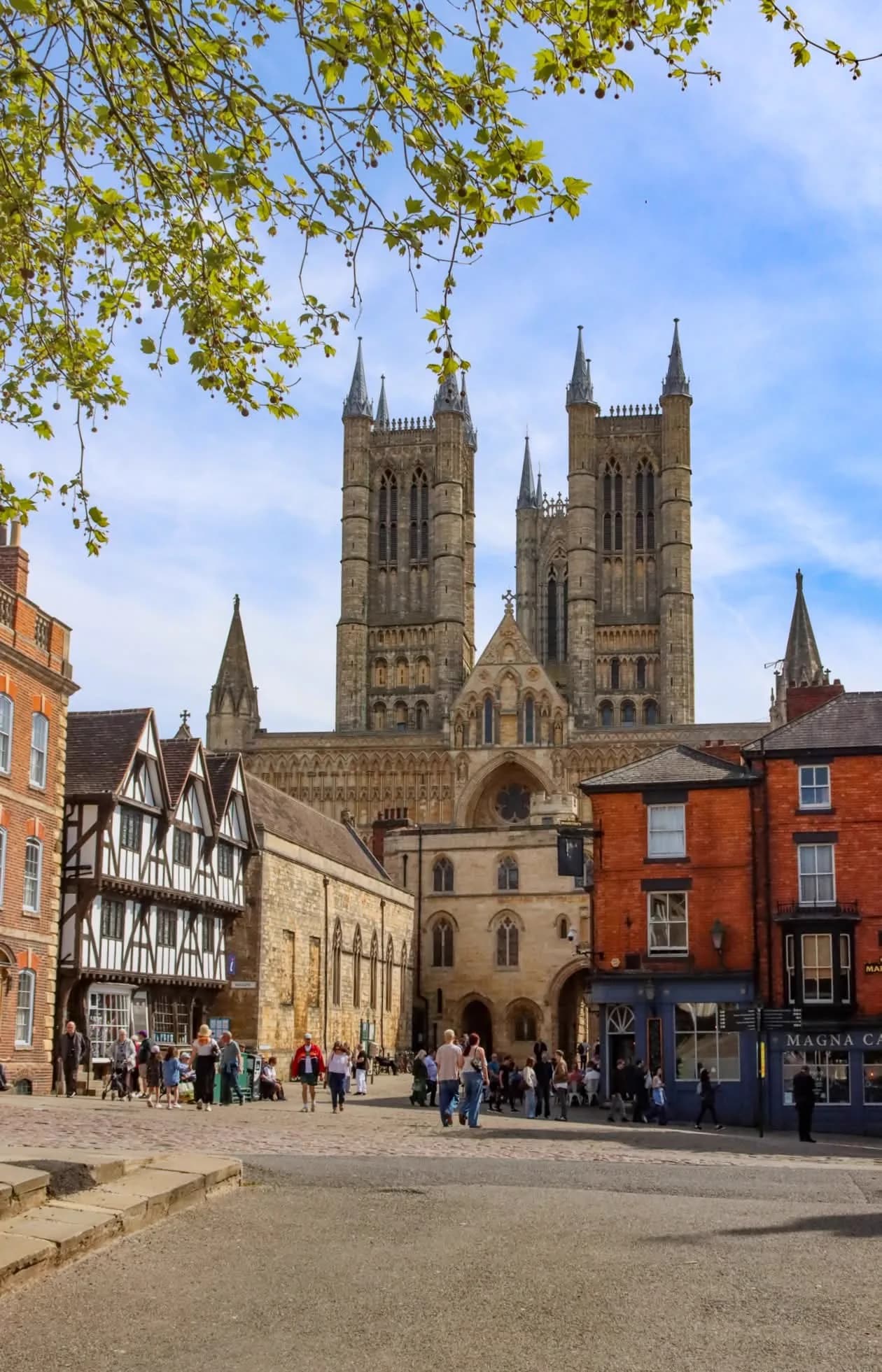 Lincoln Cathedral towering over Lincoln high street with shoppers below, the local heart of Lincolnshire where LWR Group and its trusted partner businesses operate
